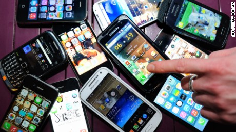 A finger points at smartphones on December 25, 2013 in Dinan, northwestern France. AFP PHOTO / PHILIPPE HUGUEN (Photo credit should read PHILIPPE HUGUEN/AFP/Getty Images)