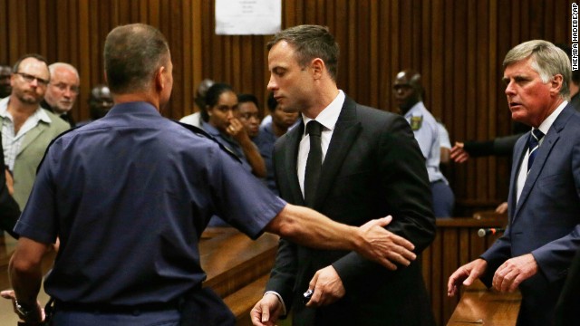 Oscar Pistorius, center, is led out of court in Pretoria, South Africa, Tuesday, Oct. 21, 2014.  Pistorius received a five-year prison sentence for culpable homicide by judge Thokozile Masipais for the killing of his girlfriend Reeva Steenkamp last year (AP Photo/Themba Hadebe)