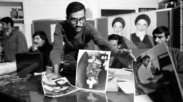 One of the student kidnappers presents pictures of the hostages during a news conference on November 8, 1979.