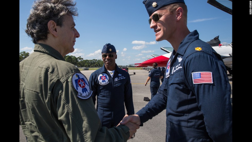 Maj. Michael Fisher shakes hands with CNN&#39;s Carl Lavin before the air show on October 9. Also on the flight line is Maj. Darrick Lee, Thunderbirds public affairs officer. 