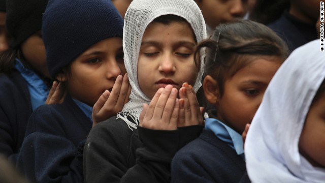 Pakistani students pray during a special ceremony for the victims of Tuesday's school attack in Peshawar, at a school in Lahore, Pakistan, Wednesday, Dec. 17, 2014. Pakistan is mourning as the nation prepares for mass funerals for over 140 people, most of them children, killed in a Taliban attack on a military-run school in the country's northwest. (AP Photo/K.M. Chaudary)