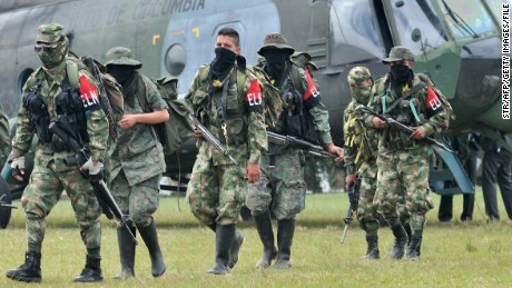Demobilized members of the ELN (National Liberation Army) arrive in Cali, Colombia on July 16, 2013. Thirty members of the ELN surrendered with their weapons. AFP PHOTO/STR (Photo credit should read STR/AFP/Getty Images)