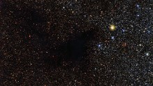 A patch of stars appears to be missing in this image from the La Silla Observatory in Chile. But the stars are actually still there behind a cloud of gas and dust called Lynds Dark Nebula 483. The cloud is about 700 light years from Earth in the constellation Serpens (The Serpent).