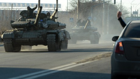 Pro-Russian separatists ride tanks in the eastern Ukrainian city of Lugansk on February 21, 2015. Ukraine&#39;s military and pro-Moscow rebels swapped scores of prisoners in rare compliance with a truce so badly breached over the past week that the US warned it could escalate sanctions on Russia within days