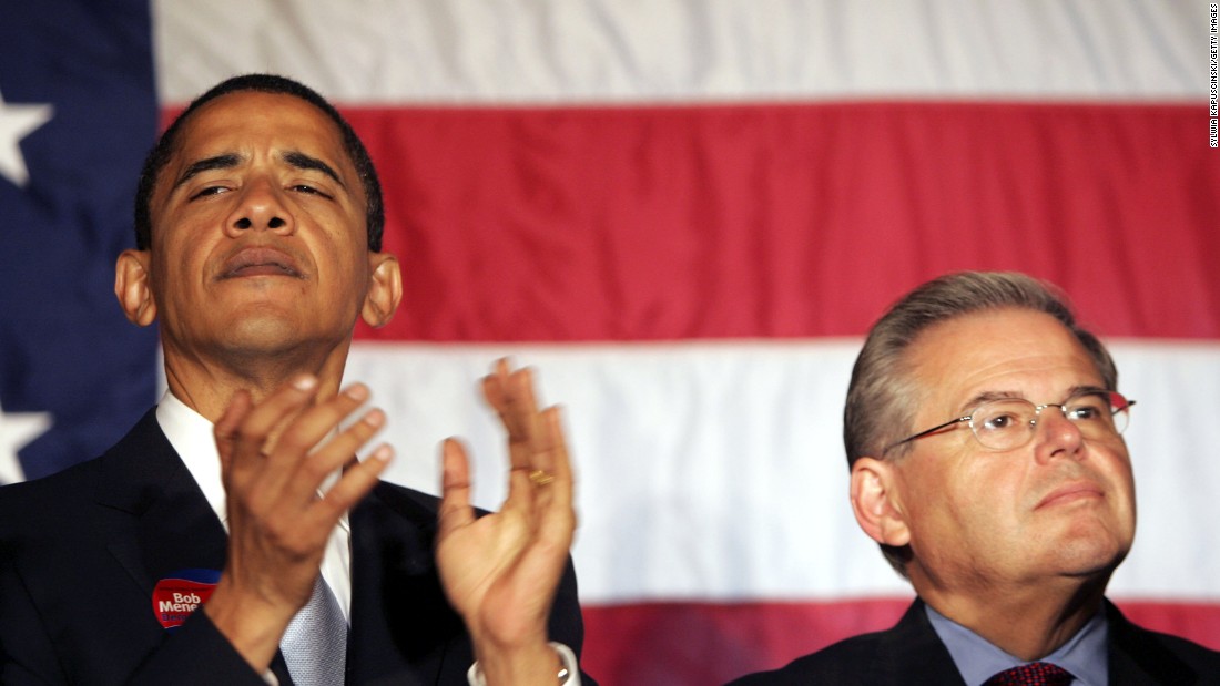 Barack Obama and Robert Menendez listen to New Jersey Governor Jon Corzine at a rally for Menendez October 12, 2006 at the Masonic Temple in Trenton, New Jersey.