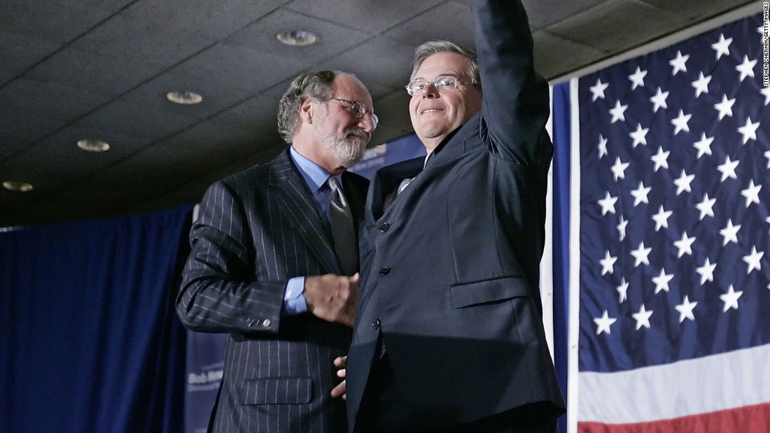 Sen. Robert Menendez (D-NJ) waves to the crowd with New Jersey Gov. Jon Corzine at his side at election night headquarters after Menendez defeated Republican challenger Thomas Kean Jr., November 7, 2006 in East Brunswick, New Jersey.