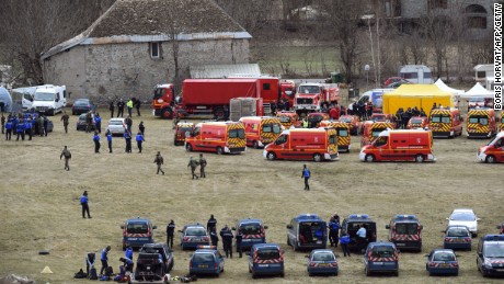 Caption:French emergency services workers (back) and members of the French gendarmerie gather in Seyne, south-eastern France, on March 24, 2015, near the site where a Germanwings Airbus A320 crashed in the French Alps. A German airliner crashed near a ski resort in the French Alps on March 24, killing all 150 people on board, in the worst plane disaster in mainland France in four decades. AFP PHOTO / BORIS HORVAT (Photo credit should read BORIS HORVAT/AFP/Getty Images)