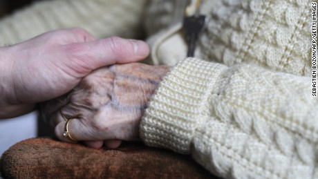 A woman, suffering from Alzheimer&#39;s desease, holds the hand of a relative on March 18, 2011 in a retirement house in Angervilliers, eastern France. AFP PHOTO / SEBASTIEN BOZON (Photo credit should read SEBASTIEN BOZON/AFP/Getty Images)