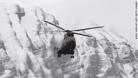 A helicopter flies near Seyne, south-eastern France, on March 25, 2015, near the site where a Germanwings Airbus A320 crashed in the French Alps. A German airliner crashed near a ski resort in the French Alps on March 24, killing all 150 people on board.