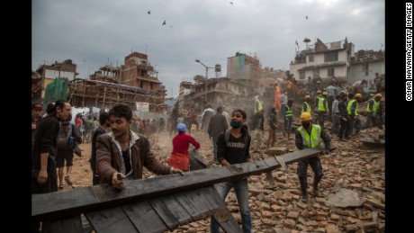 Rescue workers clear debris in Basantapur Durbar Square in Kathmandu while searching for survivors.