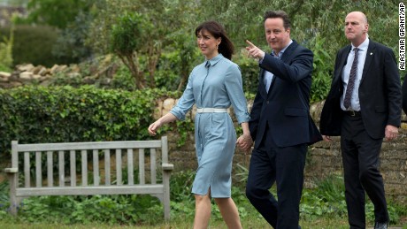 Britain&#39;s Prime Minister and Conservative Party leader David Cameron and his wife Samantha arrive to vote at a polling station in Spelsbury, England, as they vote in the general election, Thursday, May 7. 