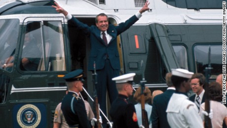 President Richard Nixon holds up V signs on the doorway of helicopter after leaving the White House following his resignation over the Watergate scandal on August 9, 1974. 