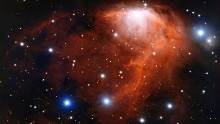 This nebula, or cloud of gas and dust, is called RCW 34 or Gum 19. The brightest areas you can see are where the gas is being heated by young stars. Eventually the gas burst outward like champagne after a bottle is uncorked. Scientists call this champagne flow. This new image of the nebula was captured by the European Space Organization's Very Large Telescope in Chile. RCW 34 is in the constellation Vela in the southern sky. The name means "sails of a ship" in Latin.