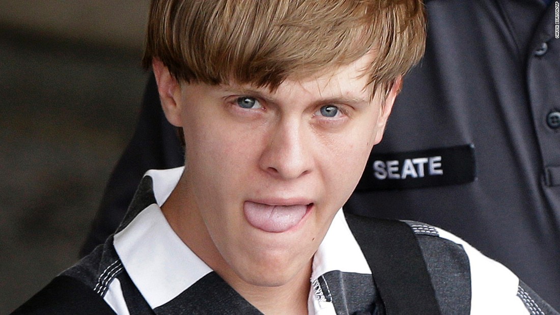 Dylann Roof, the 21-year-old charged with murdering nine people in a church shooting on Wednesday, June 17, is escorted by police in Shelby, North Carolina, on Thursday, June 18.