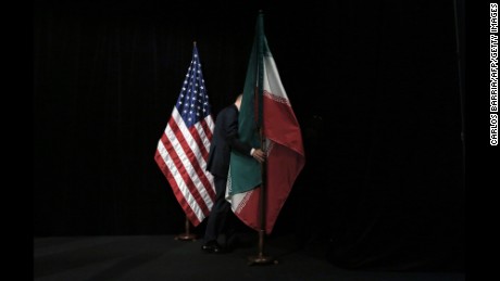 A staff removes the Iranian flag from the stage after a group picture with foreign ministers and representatives of Unites States, Iran, China, Russia, Britain, Germany, France and the European Union during the Iran nuclear talks at Austria International Centre in Vienna, Austria on July 14, 2015. Major powers clinched a historic deal aimed at ensuring Iran does not obtain the nuclear bomb, opening up Tehran&#39;s stricken economy and potentially ending decades of bad blood with the West.