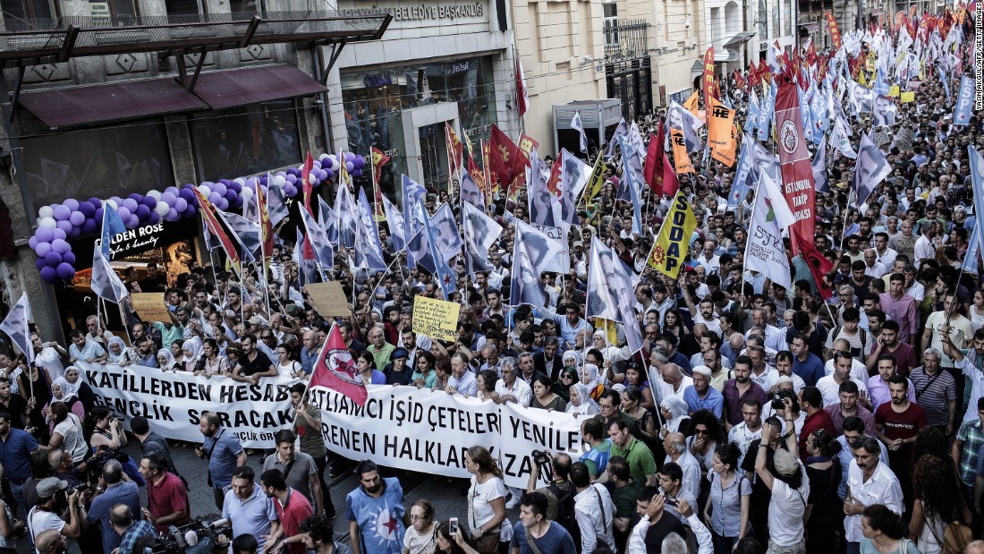 Protesters in Istanbul carry anti-ISIS banners and flags to show support for victims of the Suruc suicide blast during a demonstration on Monday, July 20.