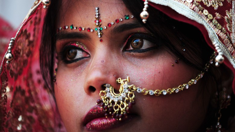 An Indian bride adorned in gold jewelry for her big day
