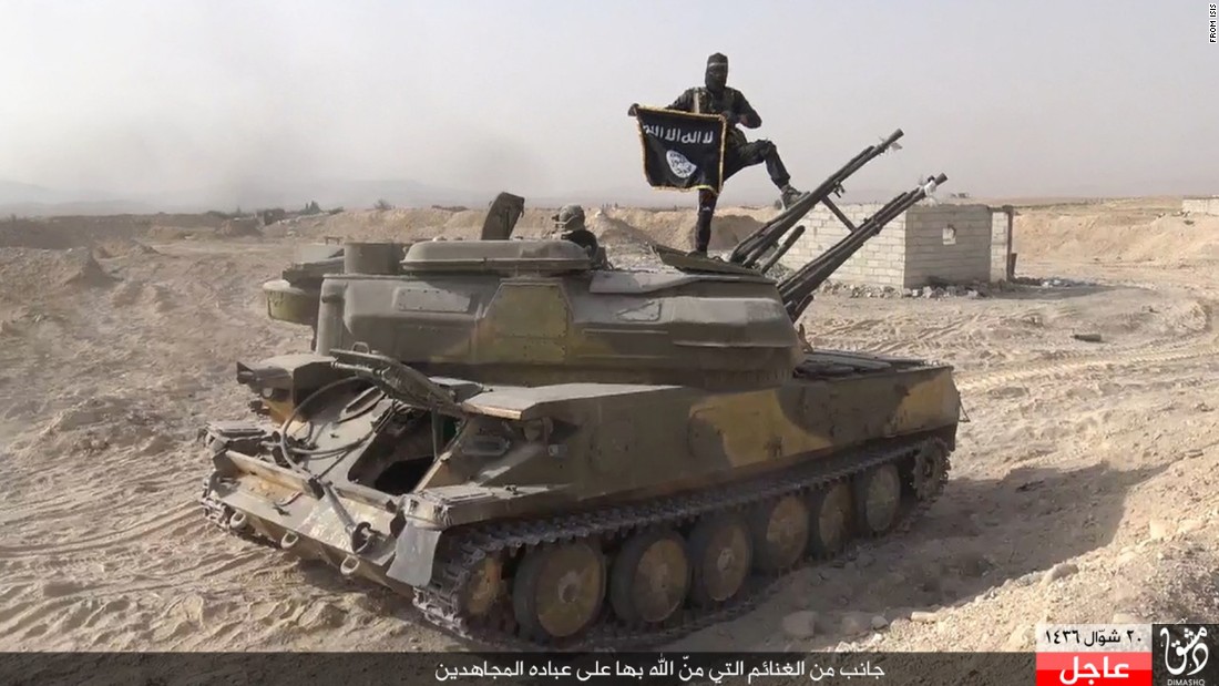 In this image taken from social media, an ISIS fighter holds the group&#39;s flag after the militant group &lt;a href=&quot;http://www.cnn.com/2015/08/07/world/syria-isis-al-qaryatayn-christians/index.html&quot; target=&quot;_blank&quot;&gt;overran the Syrian town of al-Qaryatayn&lt;/a&gt; on Thursday, August 6, the London-based Syrian Observatory for Human Rights reported. ISIS uses modern tools such as social media to promote reactionary politics and religious fundamentalism. Fighters are destroying holy sites and valuable antiquities even as their leaders propagate a return to the early days of Islam. 