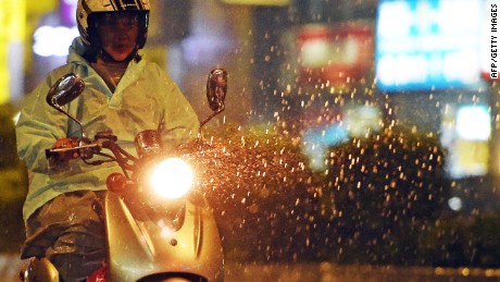 A motorcyclist rides on the street as Typhoon Soudelor approaches eastern Taiwan, in New Taipei City on August 7, 2015. An eight-year-old girl died after being swept out to sea off Taiwan as Typhoon Soudelor bore down on the island, forcing thousands to flee and troops to be placed on standby, officials said. AFP PHOTO / Sam YehSAM YEH/AFP/Getty Images