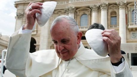 Pope Francis exchanges his skull cap with one donated by faithful at the end of the weekly general audience in St. Peter's Square at the Vatican, Wednesday, Sept. 16, 2015. (AP Photo/Gregorio Borgia)
