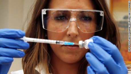 LONDON - ENGLAND - SEPTEMBER 17: Dr Felicity Hartnell, who is a clinical research fellow at Oxford University, holds the vile of the ebola vaccine called Chimp Adenovirus type 3 (ChAd3) before the first healthy UK volunteer receives an ebola vaccine at the Oxford Vaccine Group Centre for Clinical Vaccinology and Tropical Medicine (CCVTM) on September 17, 2014 in Oxford, England. (Photo by Steve Parsons-WPA Pool/Getty Images)