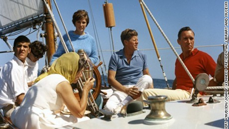 President Kennedy vacations at Hammersmith Farm. L-R: Mrs. Hugh D. Auchincloss, John Forbes Kerry, [unidentified], Janet Auchincloss (at wheel), President Kennedy, [unidentified]. Aboard the USCG yacht &quot;Manitou&quot; in Narragansett Bay, Rhode Island.