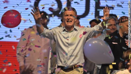 Argentine presidential candidate Mauricio Macri gestures at supporters at the party's headquarters in Buenos Aires on October 25, 2015. Buenos Aires Governor Daniel Scioli led Argentina's presidential election race as counting got under way Sunday, but it was unclear whether he would avoid a runoff against his conservative rival Mauricio Macri.  AFP PHOTO / EITAN ABRAMOVICH        (Photo credit should read EITAN ABRAMOVICH/AFP/Getty Images)