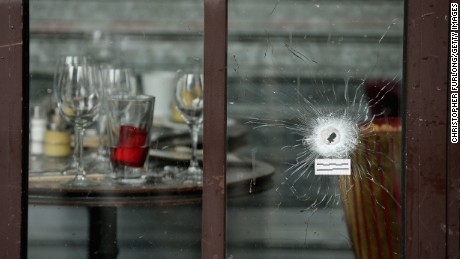 Bullets holes are seen through the glass door of a cafe near Casa Nostra on November 14.