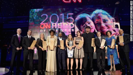 NEW YORK, NY - NOVEMBER 17:  Host Anderson Cooper (L) poses with 2015 CNN Heros at CNN Heroes 2015 - Show at American Museum of Natural History on November 17, 2015 in New York City. 25619_022  (Photo by Kevin Mazur/Getty Images for CNN)