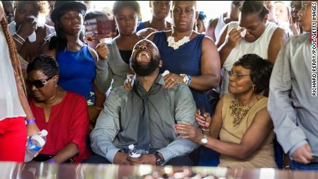 Michael Brown Sr. screams when the coffin is lowered to the floor during his son's funeral.