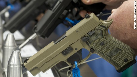 Semi-automatic handguns are displayed at the 143rd NRA Annual Meetings and Exhibits at the Indiana Convention Center in Indianapolis on April 25, 2014.