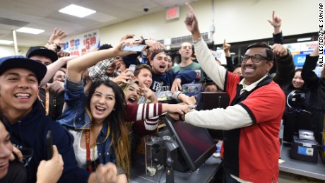 7-Eleven store clerk M. Faroqui celebrates with customers after learning the store sold a winning Powerball ticket on Wednesday, Jan. 13, 2016 in Chino Hills, Calif.  One winning ticket was sold at the store located in suburban Los Angeles said Alex Traverso, a spokesman for California lottery. The identity of the winner is not yet known. (Will Lester/The Sun via AP) MANDATORY CREDIT