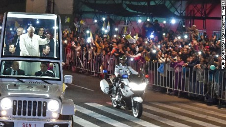 Pope Francis waves from the Popemobile upon his arrival in Mexico City on February 12, 2016. Catholic faithful flocked to the streets of Mexico City to greet Pope Francis on Friday after the pontiff held a historic meeting with the head of the Russian Orthodox Church in Cuba. AFP PHOTO/Yuri Cortez / AFP / YURI CORTEZ        (Photo credit should read YURI CORTEZ/AFP/Getty Images)