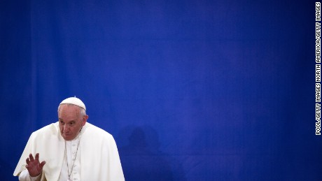 NEW YORK, NY - SEPTEMBER 25: Pope Francis waves to people inside of Our Lady Queen of Angels on September 25, 2015 in the neighborhood of East Harlem in New York City. Pope Francis is on a six-day trip to the USA, which includes stops in Washington DC, New York and Philadelphia, after a three-day stay in Cuba.  (Photo by John Taggart-Pool/Getty Images)