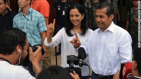 Peruvian President Ollanta Humala and First Lady Nadine Heredia gesture after voting in Lima during general elections on April 10, 2016. 
Almost 23 million Peruvians in Peru and abroad are expected to decide whether Keiko Fujimori, daughter of an ex-president jailed for massacres, should become their first female head of state in an election marred by alleged vote-buying and guerrilla attacks that killed four. / AFP / CRIS BOURONCLE        (Photo credit should read CRIS BOURONCLE/AFP/Getty Images)