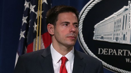 FBI Director James Comey (R) speaks as Assistant Attorney General for National Security John Carlin (L) listens during a news conference for announcing a law enforcement action March 24, 2016 in Washington, DC. 