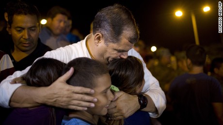Ecuador's President, Rafael Correa, kisses a group of children after meeting with local authorities at the emergency center in Portoviejo, Ecuador, Sunday, April 17, 2016.