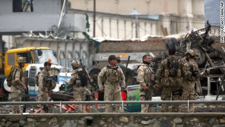 Afghan security forces inspect the site of a Taliban-claimed deadly suicide attack in Kabul, Afghanistan, Tuesday, April 19, 2016. Armed militants in Afghanistan have staged a coordinated assault on a key government security agency in the capital Tuesday morning, killing many and wounding more than 320 people. (AP Photo/Massoud Hossaini)