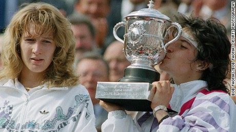 Arantxa Sanchez Vicario of Spain kissing the trophy after winning the ladies singles final of the French Open Tennis Championships held at Roland Garros, Paris, France during June 1989.  She beat Steffi Graf (left) 7-6, 3-6, 7-5.   (Photo by Bob Thomas/Getty Images).