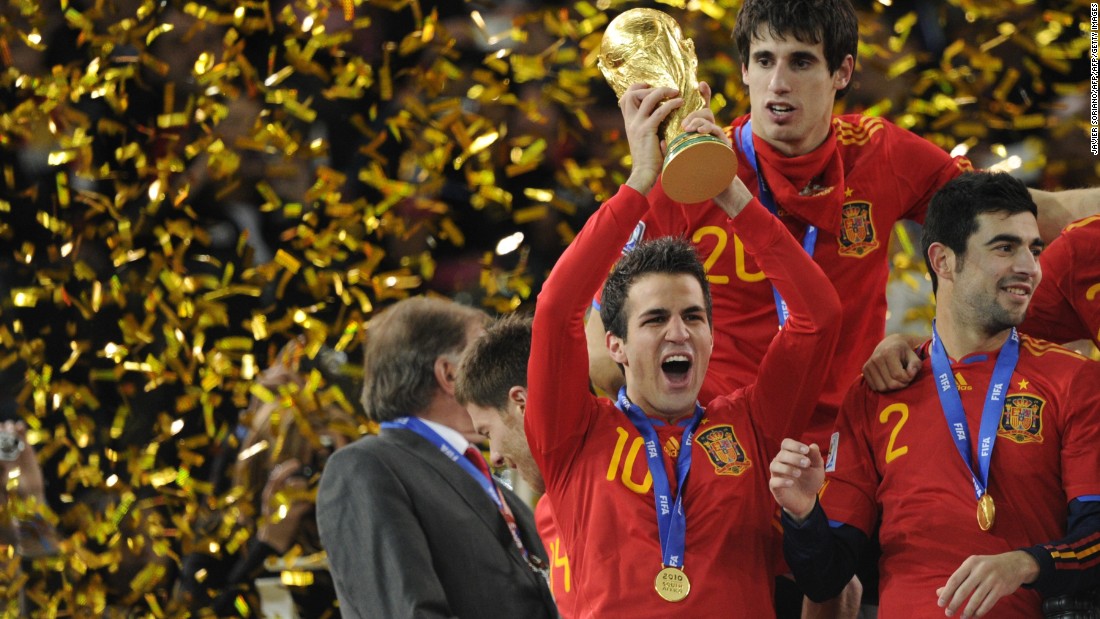 Cesc Fabregas, one of La Masia&#39;s graduates, holds aloft the World Cup trophy after Spain won the 2010 final