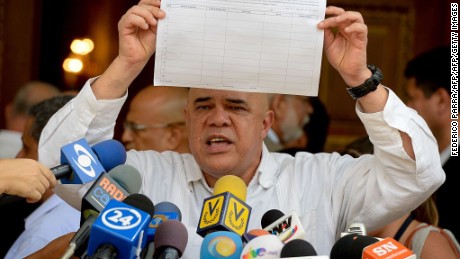 The secretary general of the Democratic Unity Roundtable (MUD), Jesus "Chuo" Torrealba, shows the form to activate the referendum on cutting President Nicolas Maduro's term short, in Caracas on April 26, 2016.
Tension in the recession-racked oil giant has reached the boiling point since the opposition won control of the National Assembly, the biggest threat yet to the socialist "revolution" launched by Maduro's late mentor Hugo Chavez in 1999. / AFP / FEDERICO PARRA        (Photo credit should read FEDERICO PARRA/AFP/Getty Images)