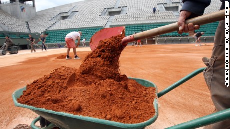 Employees set the last layer of clay on the Suzanne Lenglen court on May 7, 2012 at the Roland Garros tennis stadium in Paris, where the French Open tennis tournament will run from May 22 to June 10, 2012. AFP PHOTO JACQUES DEMARTHON        (Photo credit should read JACQUES DEMARTHON/AFP/GettyImages)