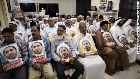 Al-Wefaq supporters hold portraits of leader Sheikh Ali Salman on May 29, in protest against his arrest.