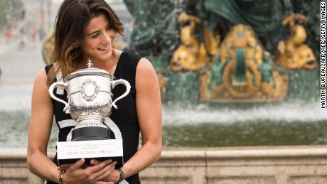 Spain&#39;s Garbine Muguruza poses for photographers with her trophy one day after winning her women&#39;s final match against US player Serena Williams at the Roland Garros 2016 French Tennis Open on June 5, 2016 at Place de la Concorde in Paris. / AFP / MARTIN BUREAU        (Photo credit should read MARTIN BUREAU/AFP/Getty Images)
