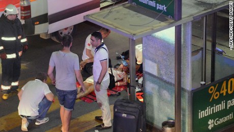 This picture obtained from the Ilhas News Agency shows emergency workers caring for an injured woman lying on the ground, after two explosions followed by gunfire hit the Turkey's biggest airport of Ataturk in Istanbul, on June 28, 2016.
At least 10 people were killed on June 28, 2016 evening in a suicide attack at the international terminal of Istanbul's Ataturk airport, Turkish Justice Minister Bekir Bozdag said. Turkey has been hit by a string of deadly attacks in the past year, blamed on both Kurdish rebels and the Islamic State jihadist group.  / AFP / ILHAS NEWS AGENCY / - / Turkey OUT        (Photo credit should read -/AFP/Getty Images)