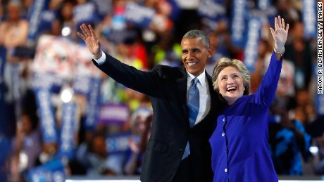 US President Barack Obama and Democratic presidential candidate Hillary Clinton wave to the crowd on the third day of the Democratic National Convention at the Wells Fargo Center, July 27, 2016 in Philadelphia, Pennsylvania. Democratic presidential candidate Hillary Clinton received the number of votes needed to secure the party&#39;s nomination. An estimated 50,000 people are expected in Philadelphia, including hundreds of protesters and members of the media. The four-day Democratic National Convention kicked off July 25.