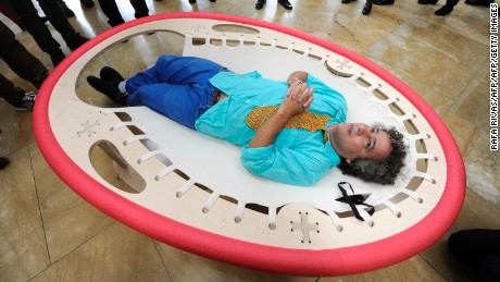 Brazilian artist Ernesto Neto lies on his artwork &quot;Looking at the Sky&quot; as he looks at his installation &quot;The Falling Body&quot; (out of frame) during the presentation of his exhibition &quot;The Body That Carries Me&quot; on February 13, 2014 at the Guggenheim Bilbao museum in the northern Spanish Basque city of Bilbao.  AFP PHOTO / RAFA RIVAS        (Photo credit should read RAFA RIVAS/AFP/Getty Images)
