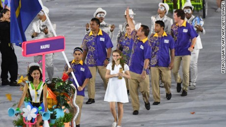 Nauru's flagbearer Elson Brechtefeld leads his delegation during the opening ceremony of the Rio 2016 Olympic Games at the Maracana stadium in Rio de Janeiro on August 5, 2016. / AFP / PEDRO UGARTE        (Photo credit should read PEDRO UGARTE/AFP/Getty Images)