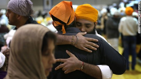 OAK CREEK, WI - AUGUST 10:  Family and friends gather at Oak Creek High School to mourn the loss of  6 members of the Sikh Temple of Wisconsin on August 10, 2012 in Oak Creek, Wisconsin. Bhai Seeta Singh, Bhai Parkash Singh, Bhai Ranjit Singh, Satwant Singh Kaleka, Subegh Singh, and Parmjit Kaur Toor were killed when Wade Michael Page, a suspected white supremacist, went on a shooting rampage at the temple August 5. Page also died at the temple after being shot by police then shooting himself.  (Photo by Scott Olson/Getty Images)