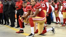 Colin Kaepernick #7 and Eric Reid #35 of the San Francisco 49ers kneel in protest during the national anthem prior to playing the Los Angeles Rams in their NFL game at Levi&#39;s Stadium on September 12, 2016. 